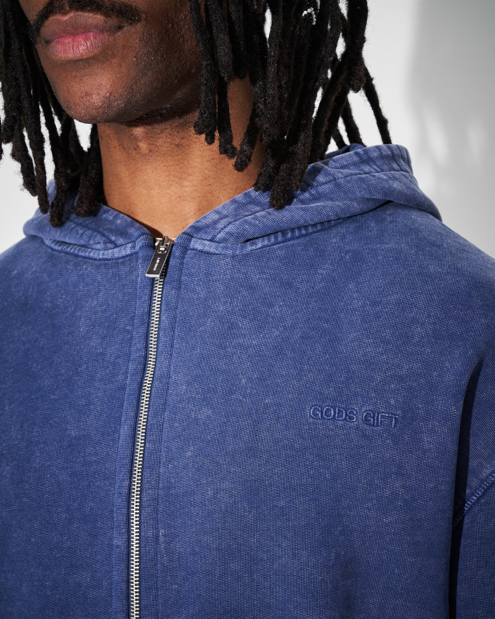 zip detail of heavyweight hoodie in acid wash blue
